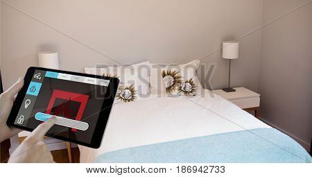 Digital composite of Hands using smart home application on digital tablet in bedroom