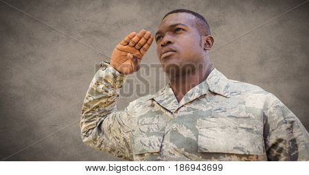 Digital composite of Soldier saluting against brown background with grunge overlay