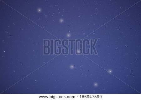 The constellation of a big bear in the night blue sky. The starry sky sparkles with the small lights of billions of stars.