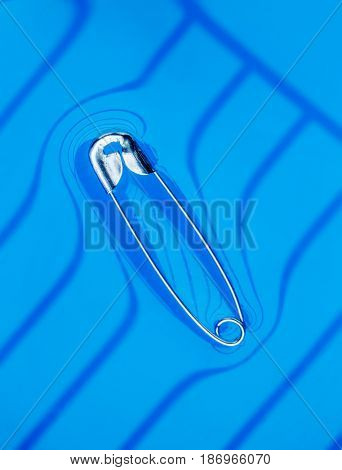 Physical experiment - pin floating on water surface.