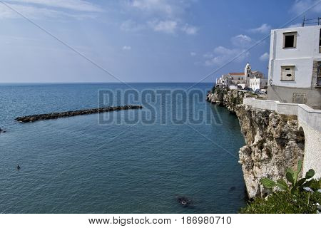 Vieste coastal cliff with houses and church