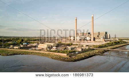 An aerial view of the decommissioned Tilbury A and B fossil fuel power stations located on the banks of the River Thames in Essex England.