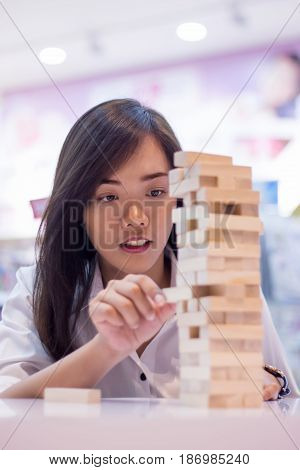 Asian Lady Play Jenga Game