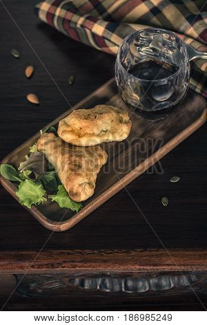 Two Empanadas And A Glass Of Wine In A Chic Retreat.