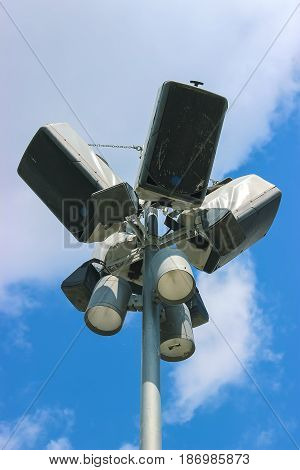 close-up on a rusty pole and luminaire ring with lighting fixtures