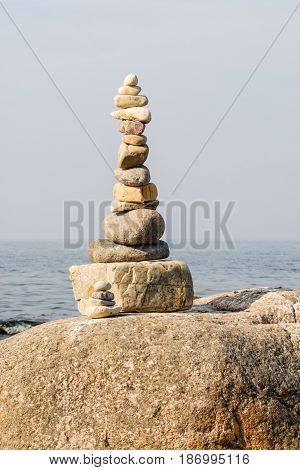 stacked stones with the sea in the background