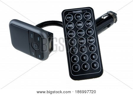 Mp3 Fm transmitter with remote control isolated on white background. It plays mp3, you listen on fm channel on car radio.
