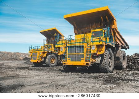 Large Quarry Dump Truck. Loading The Rock In Dumper. Loading Coal Into Body Truck. Production Useful