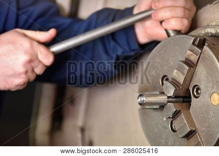 The Worker Installs A New Metal Part For Processing On The Cnc Machine. Hands Of The Worker Close Up