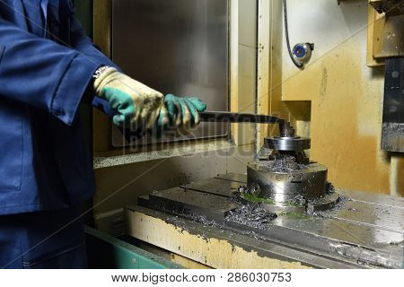 The Worker Installs A New Metal Part In The Chuck Spindles For Processing On The Cnc Machine. Hands 