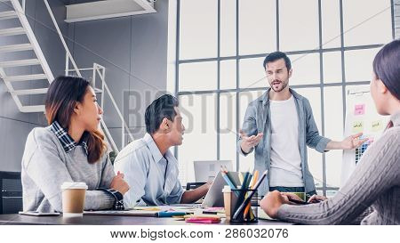 Creative Director Team Lead Brainstrom Branding Project With Designer Team At Meeting Table.discussi
