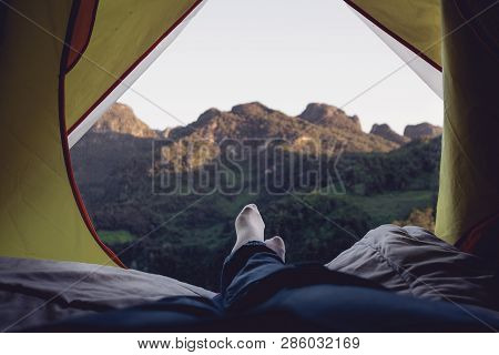 Relax Woman Lying Down And Cross Leg On Blanket In Tent And Looking At Mountain View In Sunset Time 