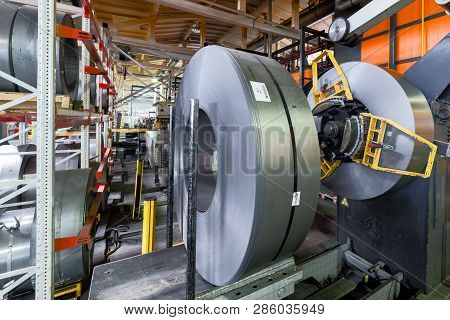 Cold Rolled Steel Coil On Decoiler Of Machine In Metalwork Manufacturing. Modern Equipment For Sheet