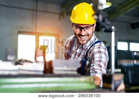 Turner Worker Is Working On A Lathe Machine In A Factory.