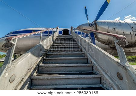 Old, Worn Passenger Gangway. Gangway Attached To The Aircraft.