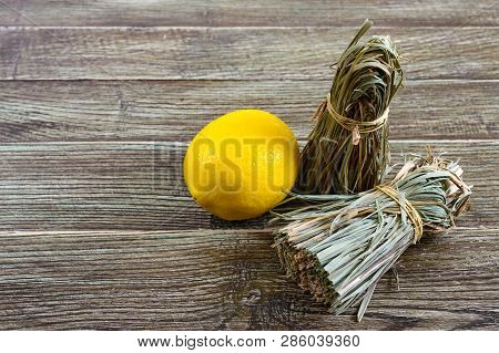 Organic Dry Lemongrass (cymbopogon Flexuosus) In Bunches And Lemon Fruit On A Wooden Table. Herbs Fo