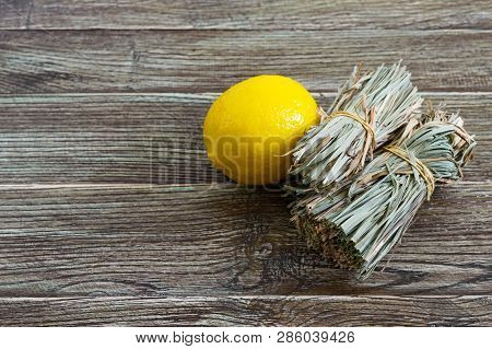 Organic Dry Lemongrass (cymbopogon Flexuosus) In Bunches And Lemon Fruit On A Wooden Table. Herbs Fo