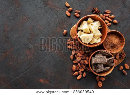 Natural  Cocoa Powder, Butter, Chocolate  And Cocoa Beans  On A Black  Background