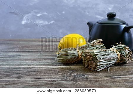 Organic Dry Lemongrass (cymbopogon Flexuosus) In Bunches And Lemon Fruit On A Wooden Table. Herbs Fo
