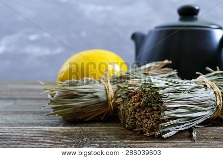 Organic Dry Lemongrass (cymbopogon Flexuosus) In Bunches And Lemon Fruit On A Wooden Table. Herbs Fo
