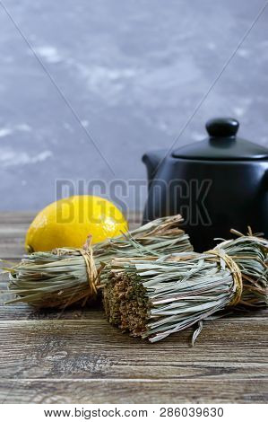 Organic Dry Lemongrass (cymbopogon Flexuosus) In Bunches And Lemon Fruit On A Wooden Table. Herbs Fo