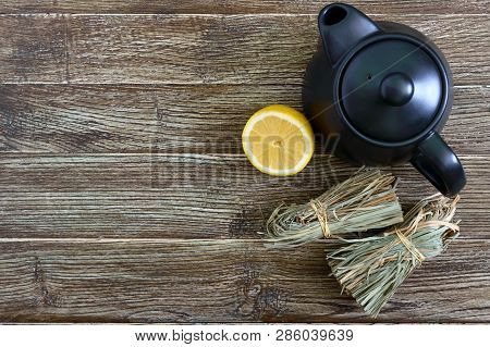 Organic Dry Lemongrass (cymbopogon Flexuosus) In Bunches And Lemon Fruit On A Wooden Table. Herbs Fo