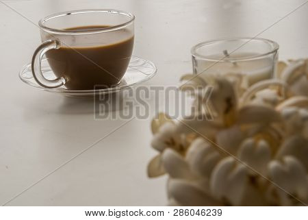 Coffee And Flowers On A White Table That Looks Relaxed