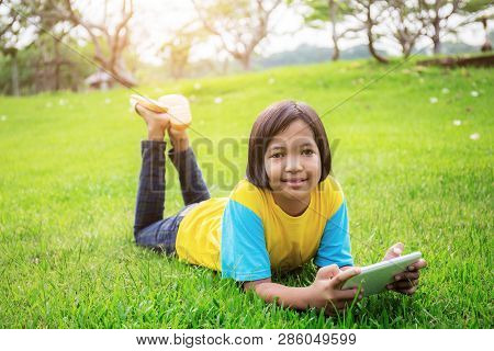 Asian Girls Are Happy On Lawn In The Park.