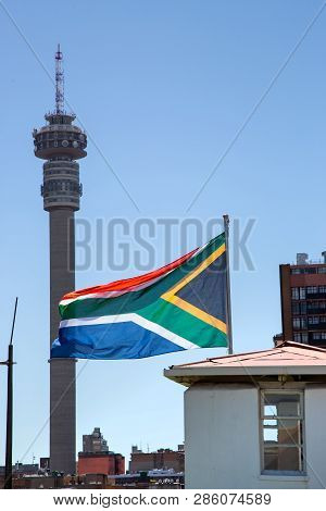 Johannesburg, South Africa, 17th February - 2019: South African Flag With City Buildings In Backgrou