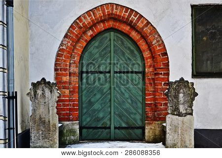 Old Wooden Green Door. The Home Of The Three Brothers In Riga. Latvia