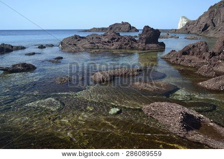 The Beach Of Porto Corallo In Background Pan Di Zucchero