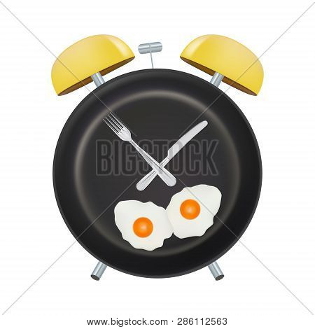 Alarm Clock Face With A Fork And Spoon Isolated On A White Background. Concept Of Intermittent Fasti