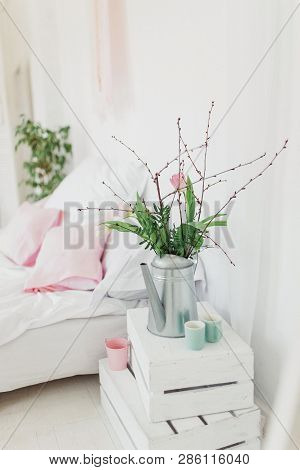 Zinc Watering Can With Pink Tulips Over White Background In Bedroom. Spring
