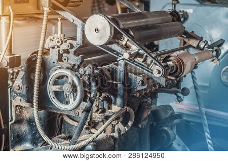 Vintage Printing Machine For Carving In Printing. Part Of The Old Mechanism, Regulators, Gears.