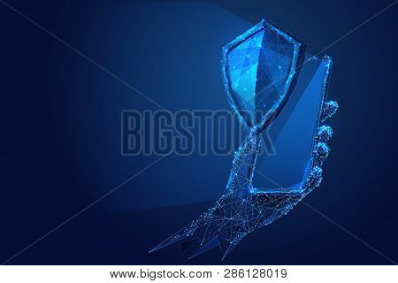 Phone In A Hand With Knight Shield On Blue Smartphone Screen. Abstract Low-poly Wireframe Vector Tec