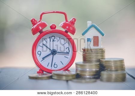 Mini House On Stack Of Coins,money And House,  Mortgage, Savings Money For Buy House And Loan To Bus