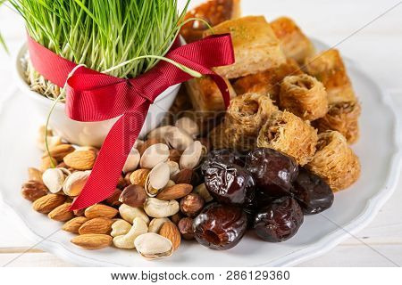 Nowruz Holiday Concept - Grass, Baklava Sweets, Nuts And Seeds, Copy Space