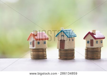 Mini House On Stack Of Coins,money And House,  Mortgage, Savings Money For Buy House And Loan To Bus
