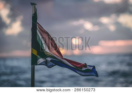 Sout African Flag Blowing On The Tail Of A Boat On The Ocean