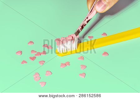Love Concept Minimal. Bright Colorful Background With Teethbrush And Candy Hearts In Pink And Turquo