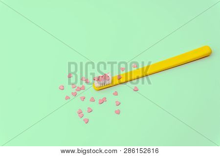 Love Concept Minimal. Bright Colorful Background With Teethbrush And Candy Hearts In Pink And Turquo