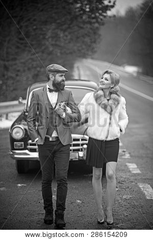 Escort Of Girl By Security. Escort Concept With Bearded Driver And Luxury Girl In Retro Car