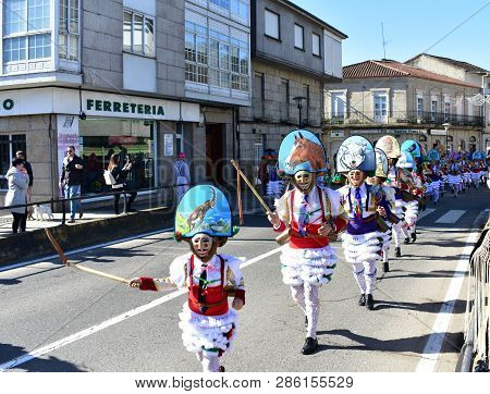 Verin, Spain, 24 Feb 2019. Famous Carnival And Street Parade With Cigarrons Costumes. Ourense Provin