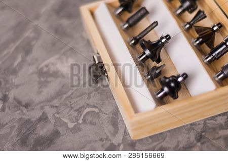 Set Of Steel Router Bit For Milling Cutter In Rectangle Wooden Box With Metal Lock On Old Broken Wor