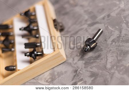 Set Of Steel Router Bit For Milling Cutter In Rectangle Wooden Box With Metal Lock Near One Bit On O