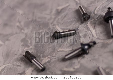 Scattered Set Of Steel Router Bit For Milling Cutter On Old Broken Worn Gray Concrete Floor With Cop