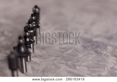 Row Of Lot Of Steel Router Bits For Milling Cutter On Old Broken Worn Gray Concrete Floor With Copy 