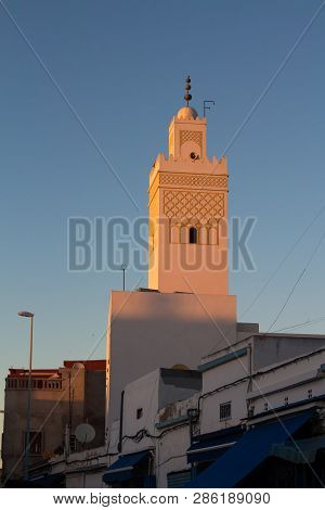 Upper Part Of A Street With A Tower Of A Mosque, Enlighted By Evening Sunlight During Sunset, Creati