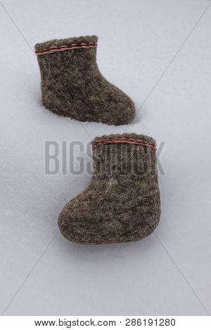 A Pair Of Russian Felt Boots Standing On White Snow In Winter Close-up