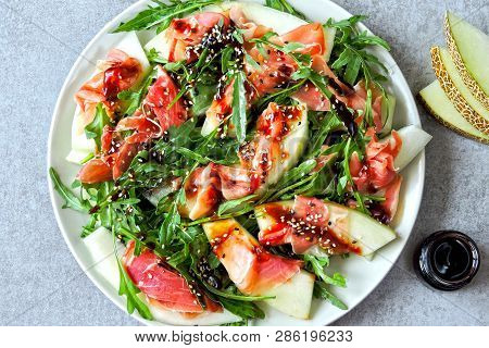 Salad Melon Prosciutto With Arugula. Italian Cuisine. Fresh Melon With Prosciutto. Traditional Itali